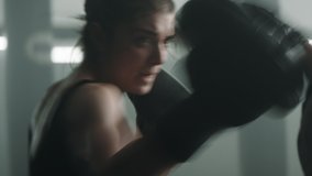 EXTREME CU Portrait of Caucasian female boxer practicing punches with her coach on a boxing ring. Shot with 2x anamorphic lens - Powered by Shutterstock - Get 15% off with code: PIKWIZARD15