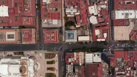 Aerial birds eye overhead top down view of buildings in downtown with Torre Latinoamericana in center. Rotating and slowly zooming in footage. Mexico city, Mexico.