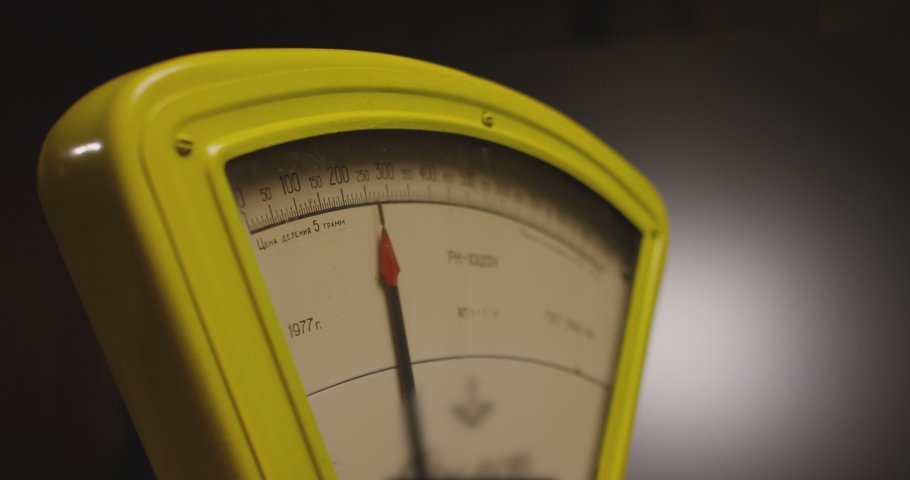 Working vintage weigher with arrow . The scales are unsteady until they balance . Measurement instrument in kilogram for food weight control . Studio shot on RED EPIC Cinema Camera with strobe light . | Shutterstock HD Video #1073924636