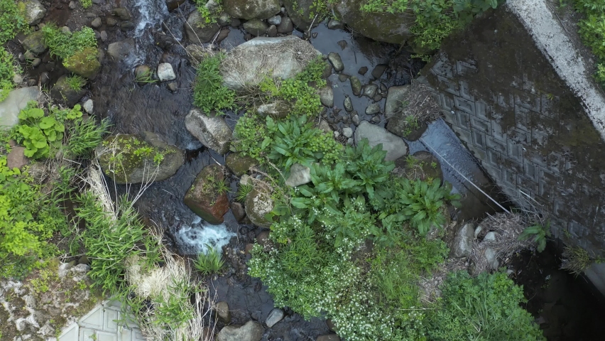 Aerial top down view of stream running through rural Japan, Tottori Prefecture