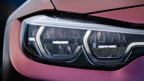 KYIV-15 MAY,2021: Video clip of laser led head lights on BMW M3 F80 Sport Car wrapped in chameleon vinyl wrap on Drift And Cars Show. Beautiful modern German vehicle in details