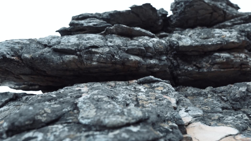 The Structure and Texture of the Stone Rock Consisting of Ancient Layers. Cliff of Rock Mountain Royalty-Free Stock Footage #1073941571
