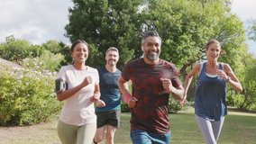 Healthy group of multiethnic middle aged men and women jogging at park. Happy mixed race couples running together. Mature friends running together outdoor. - Powered by Shutterstock - Get 15% off with code: PIKWIZARD15