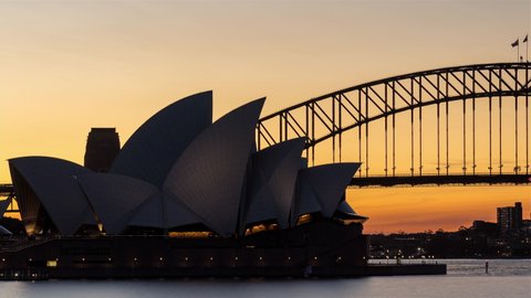 Sydney, NSW, Australia - 18th March 2021 - Timelapse of Sydney Opera House and Sydney Harbour Bridge - Day to Night