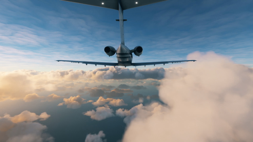 Rear view of a private airplane flying over clouds: Aerial view of a small jet plane during a flight between two layers of clouds during sunset