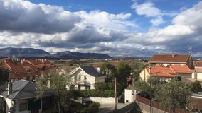 Time lapse video of a town with clouds moving in the background