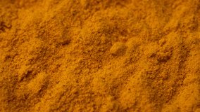 turmeric powder top view, rotate. Condiment or dietary supplement. 4K UHD video
