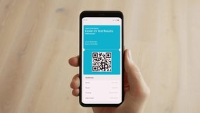 Vaccine passport on phone. Covid-19 immune digital certificate concept. Scanning QR Code showing health ID and negative test results. POV Close-up 4k - Powered by Shutterstock - Get 15% off with code: PIKWIZARD15