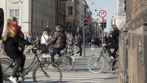Copenhagen , Denmark - 04 20 2021: Crowd of cyclists on Danish street in middle of city