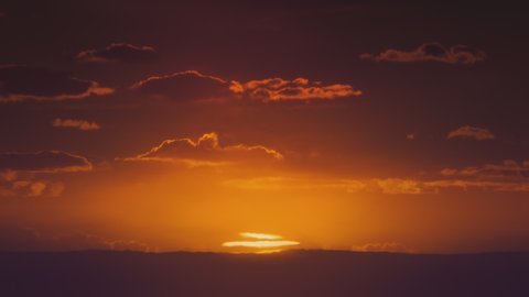 African sunset time lapse with big sun and backlit clouds. Cinematic 4k footage.