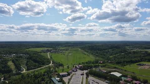 Aerial drone view of ski club hill and village in the summer.