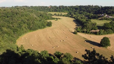 Europe, Italy , Rome - drone aerial view of countryside  landscape with hay bales to dry in a sunny field - amazing nature in Lazio Roma capital 