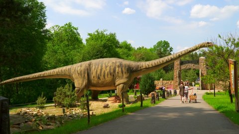 Russia, Belgorod May 30, 2021 Seismosaurus in Dino Park. A huge dinosaur among trees and among people. Giant pangolin of the Mesozoic era. Diplodocus robotic model on display Exhibition exhibit.