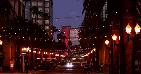 Twilight view of traffic passing through Center Street in downtown Anaheim, California, USA.
