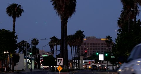 Twilight view of traffic passing through Lincoln Ave in downtown Anaheim, California, USA.