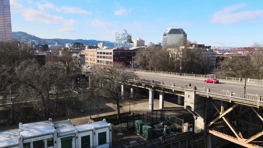 Amazing Drone shot of World Famous Portland Oregon Old Town Reindeer Sign as Drone flies over burnside bridge on a beautiful sunny day Aerial Drone View Waterfront