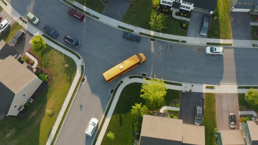 Yellow school bus. Top down birds eye aerial of kids children and students as they run and enter at bus stop. Public education transportation theme. | Shutterstock HD Video #1073995532