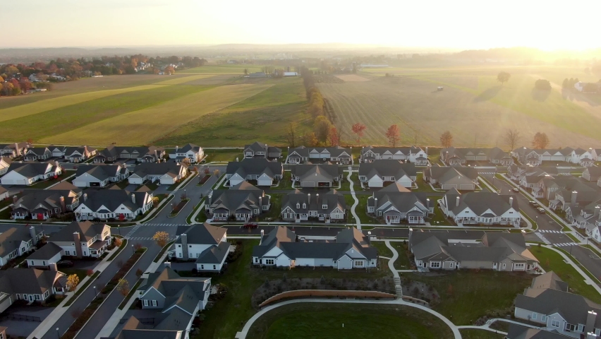 American homes. Rural broadband access. Wifi internet speed. Homes in USA beside rural fields during sunset. Royalty-Free Stock Footage #1073996606