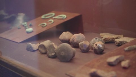 oxidized iron jewels of ancient civilization in an archaeological museum case