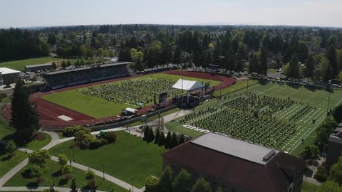 Students With Family On An Open Field During Graduation Ceremony Amidst Pandemic In Tacoma, Washington, USA. - aerial