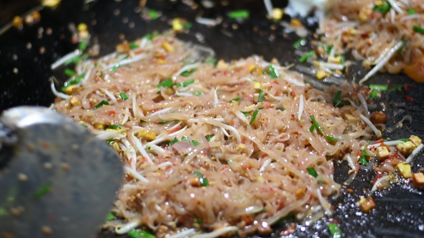 Cooking Stir-Fried Noodles (PAD THAI) Thai Food Street Food - Slowmotion Royalty-Free Stock Footage #1073999585