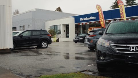 Vancouver , British Columbia , Canada - 03 24 2018: Panning Shot of a Hyundai Small SUV Pulling into a Dealership.