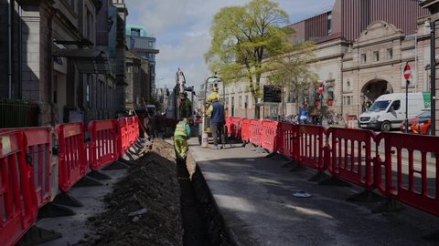 Aberdeen , Aberdeenshire , United Kingdom (UK) - 05 11 2021: Workmen digging a trench on School Hill Aberdeen outside the Art Gallery
