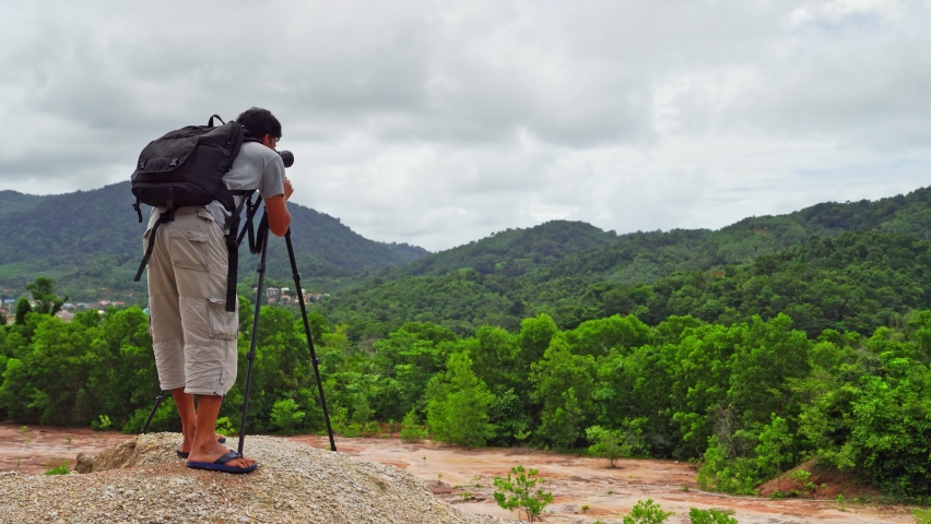 Man Taking Photo At Mountain Peak Tourist man take photo Landscape forests Mountain