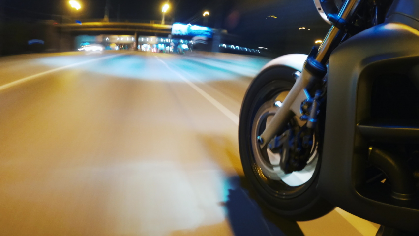 Fast Driving Bike on Streets of Night City Time Lapse. Speed Motion in Cityscape Illumination Neon. Wheel Fast Driving. Pov View Motorcyclist Drives on Motorcycle on Road in the City Hyper Lapse 4k Royalty-Free Stock Footage #1074009557