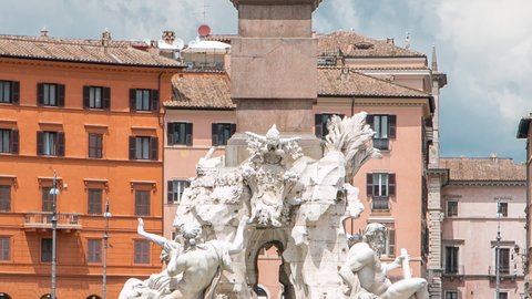 Piazza Navona, the fountain of four rivers timelapse. People sitting and walking around. Cloudy sky. Italy, Rome