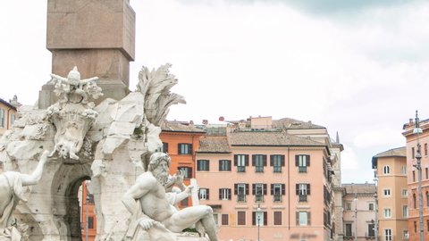 Piazza Navona, the fountain of four rivers timelapse. People sitting and walking around. Cloudy sky. Italy, Rome