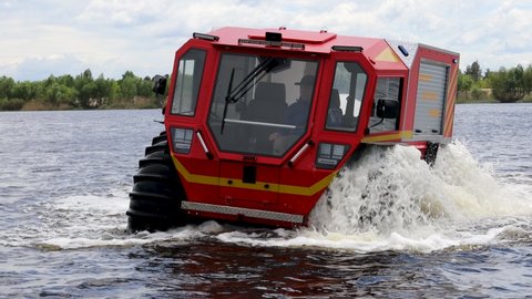 Kyiv, Ukraine - May 24 2021: Ukrainian all-terrain amphibious rescue vehicles for rough and soggy terrain. Vehicle floats down the Dnipro River in Kyiv, Ukraine