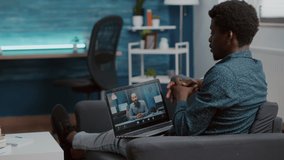 Black american man using laptop for online internet conference chat with his coworkers, remote working from home, teleconference web communication with webcam. Black guy distance technology talking