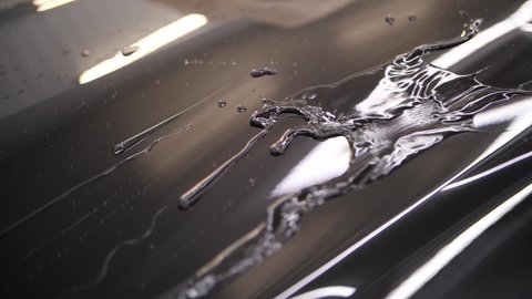 drops of water flow down the body of the car