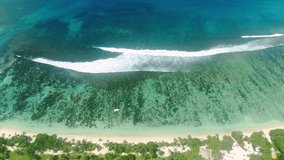 Video from a drone of a beautiful famous beach in the Seychelles called Baie Lazare.