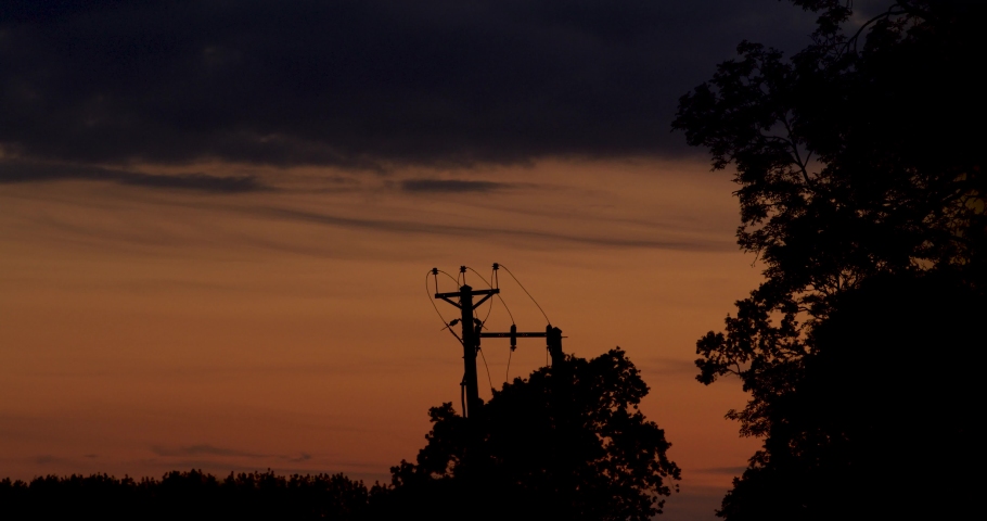 Telephone line silhouetted in the summer evening sky - Shot on RED Gemini in 5K - Cheshire, UK