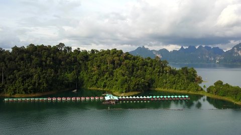 Floating Raft Houses and Mountain Landscape Background, Khao Sok National Park,Thailand, Aerial Rising