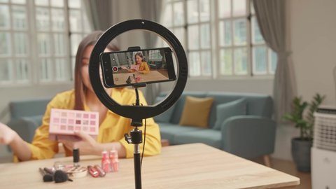 Display Of Smartphone Recording Video Blog For Asia Beauty Blogger Woman With Make-Up At Home Studio. Influencer Vlogger Girl Live Streaming Cosmetics Masterclass. Online Learning And Marketing Concep