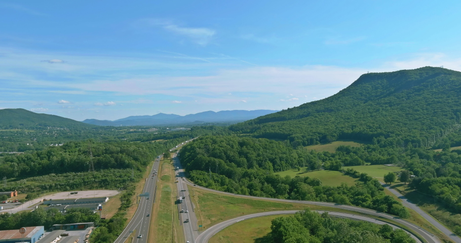 View of the mountains in West Virginia valley of highway intersection traffic circle road in Daleville town Royalty-Free Stock Footage #1074045971