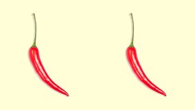 Stop Motion Animation. Two hot chili peppers revolve around their axis on a yellow background. Seamless video