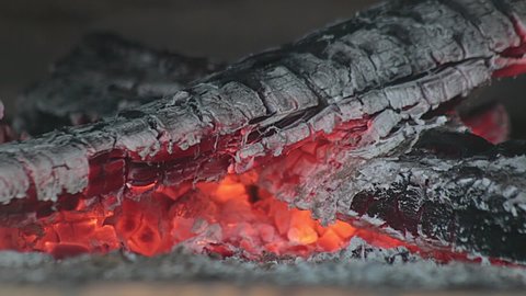 Wooden logs burning inside rustic oven. Dying fire close-up still shot