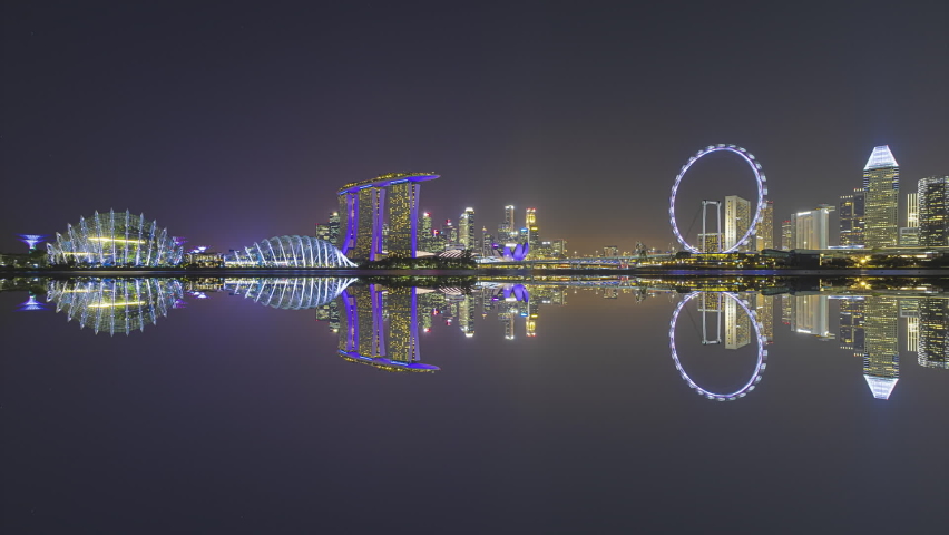 Beautiful Time lapse of Night to Day of Singapore skyline with reflection at sunrise.  Prores. 4K available. Royalty-Free Stock Footage #1074060944