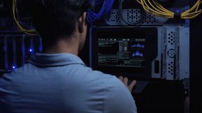 IT Engineer Enters Information Using a Flat Keyboard on Modern Screen Interface. Inside Secure Server Room.  Data Center. Close Up. Engineer over Shoulder.  - Powered by Shutterstock - Get 15% off with code: PIKWIZARD15