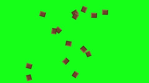 Explosion of pieces of chocolate, green background.