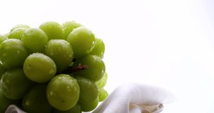 Video of two Muscat Grapes slowly rotating on a White background.