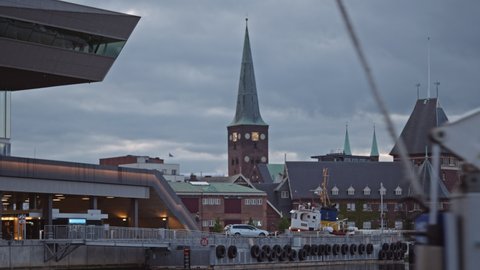 Wide Point Of View Shot Of Aarhus Cathedral And Moored Boat, At Dusk