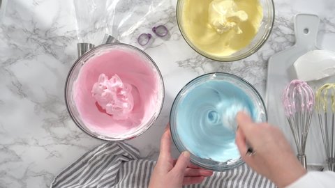 Step by step. Flat lay. Mixing food coloring into the meringue to bake unicorn meringue cookies.