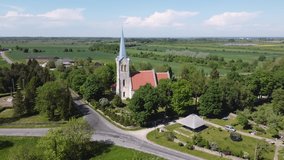 Christian church in small Estonian village, top view from dron