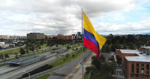 Drone view of giant Colombian flag in Bogota, Colombia, wide angle spinning shot