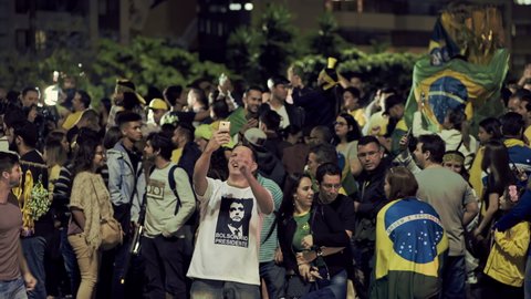 Sao Paulo , Sao Paulo , Brazil - 10 28 2018: Crowd of supporters of the president elected Jair Messias Bolsonaro celebrate his victory in Paulista Avenue, the most iconic of the financial capital of B